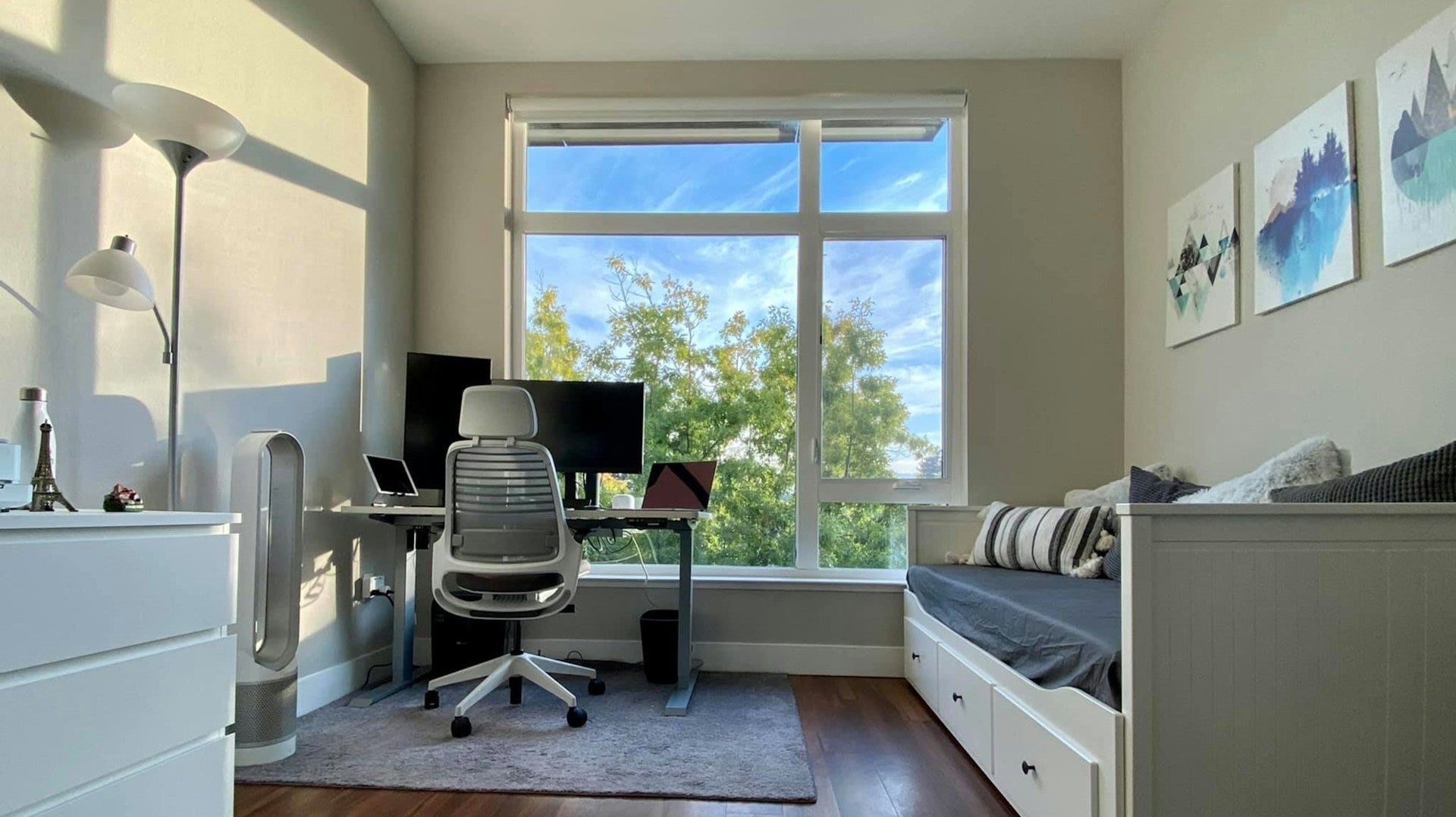 Bright room with desk and daybed, showcasing modern home office guest room ideas in a compact space.