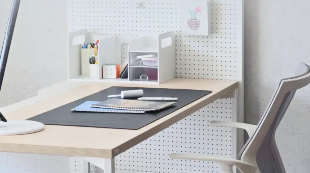 Minimalist home office setup guide featuring a clean desk, pegboard organizer, and ergonomic chair in a compact workspace.