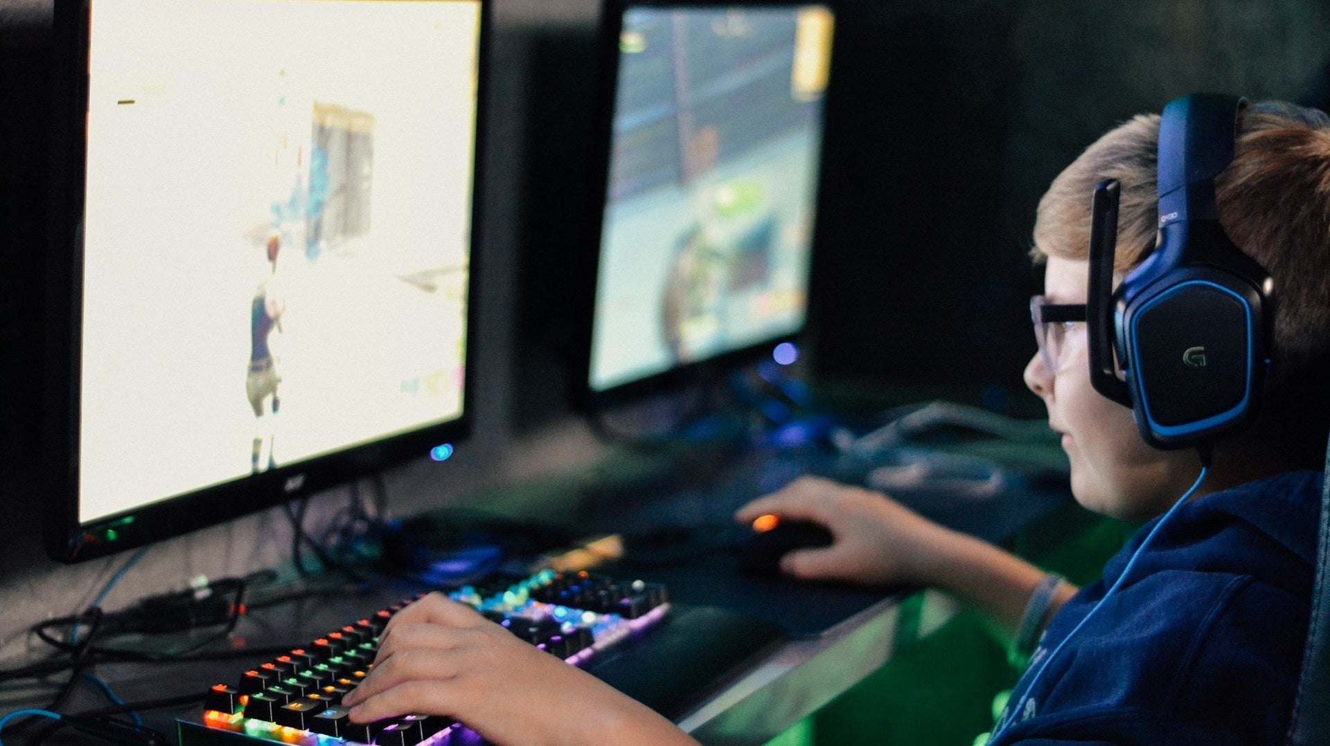 A young boy playing video games, very serious, makes you ask how gamers make money. Image by Alex Haney via www.unsplash.com
