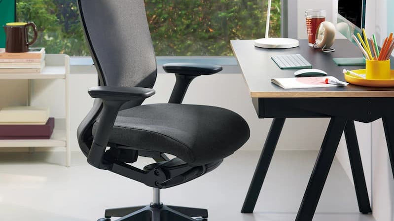 Modern workspace with ergonomic chair and desk, a great example of how to set up an office for comfort.