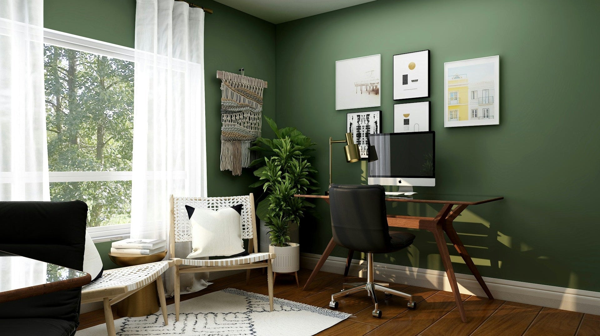 Modern office design for home with green walls, wooden desk, swivel chair, and natural light from a large window.