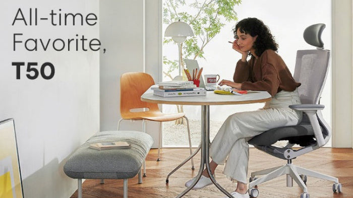 Minimalist work from home setup with laptop, desk mat, and natural lighting.
