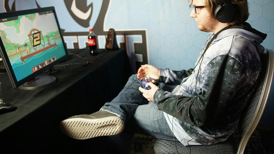a man playing a game, in dire need of a gaming chair mat. Image by Stem List via www.unsplash.com
