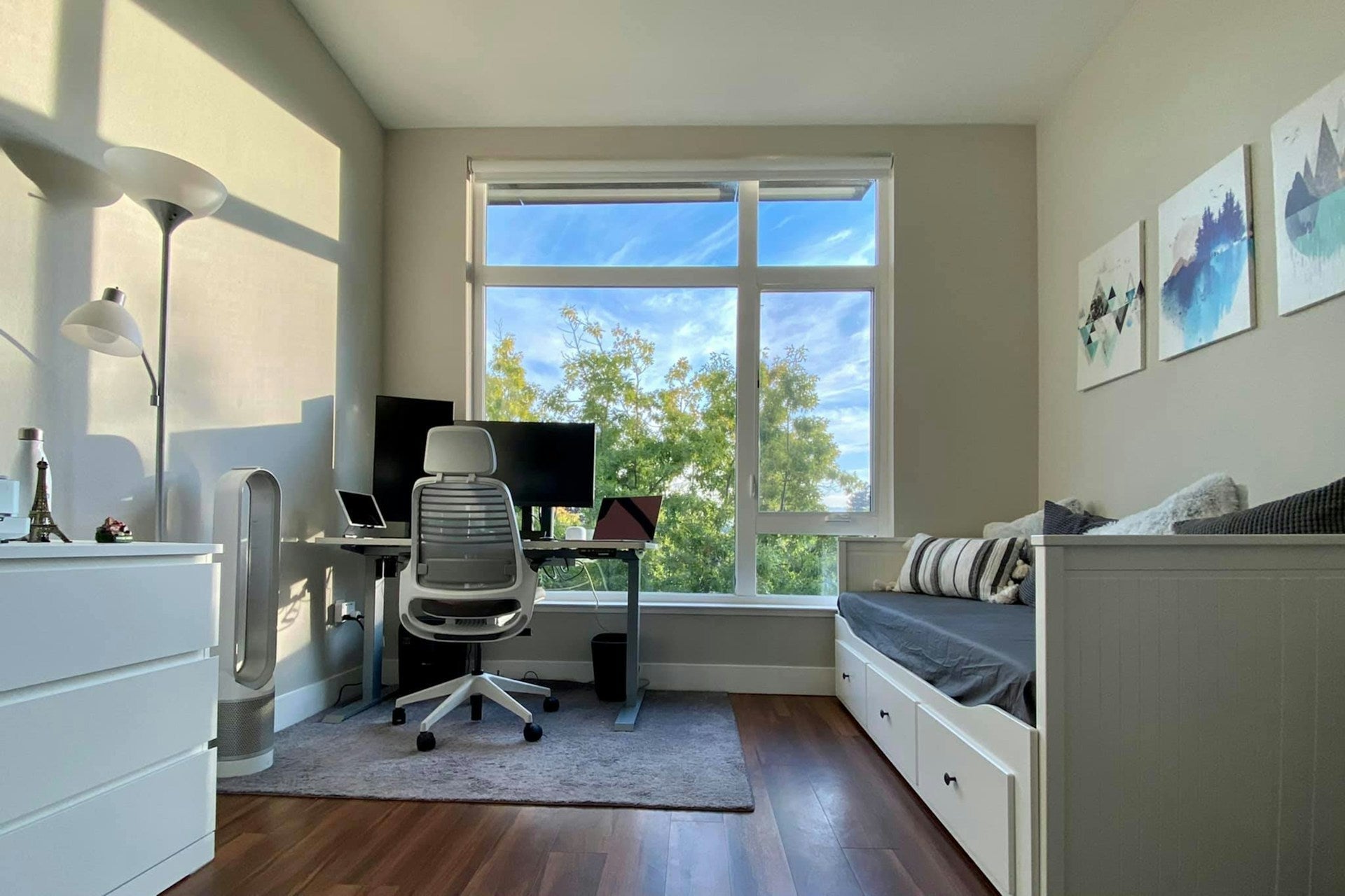 Bright room with desk and daybed, showcasing modern home office guest room ideas in a compact space.