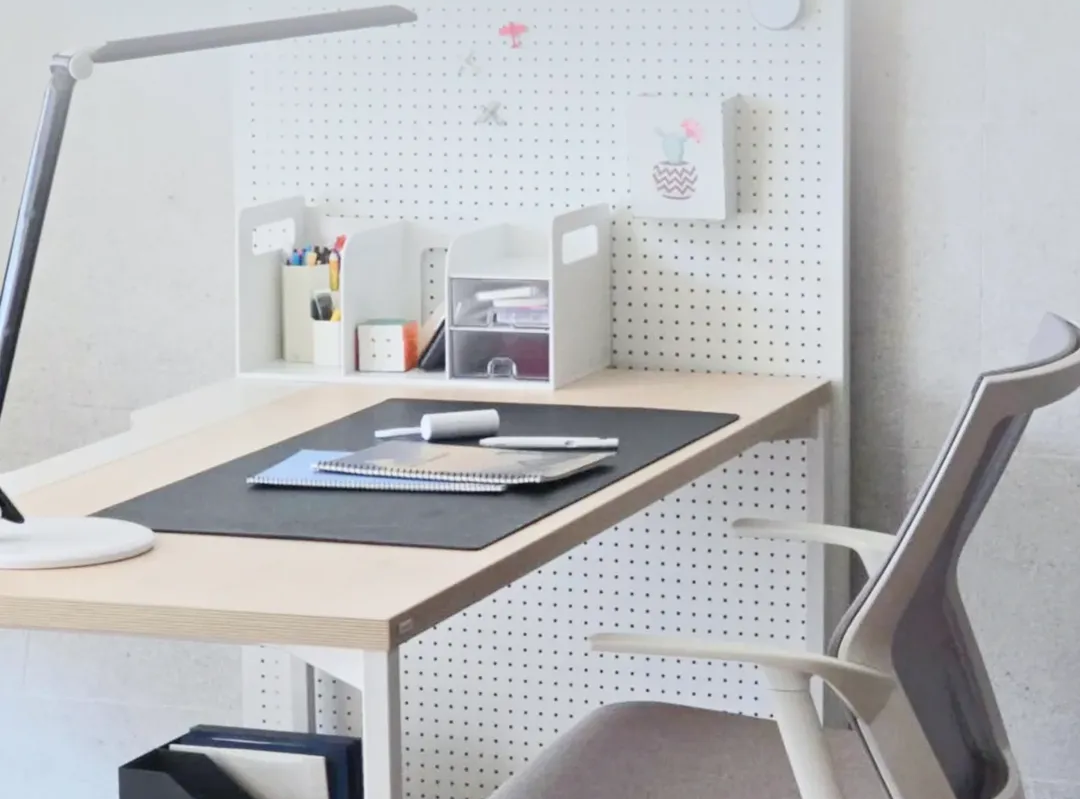 Minimalist home office setup guide featuring a clean desk, pegboard organizer, and ergonomic chair in a compact workspace.