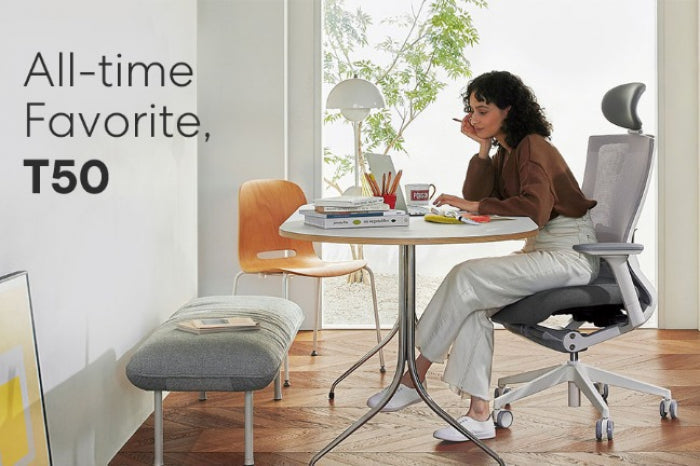Minimalist work from home setup with laptop, desk mat, and natural lighting.