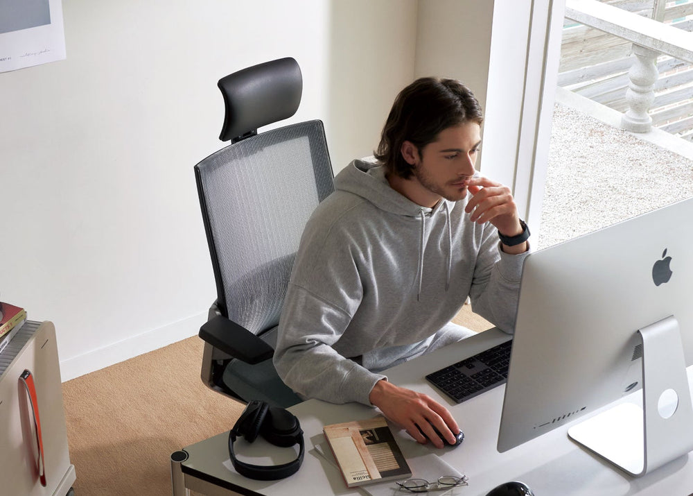 A professional working at a desk while seated in a SIDIZ T80 chair