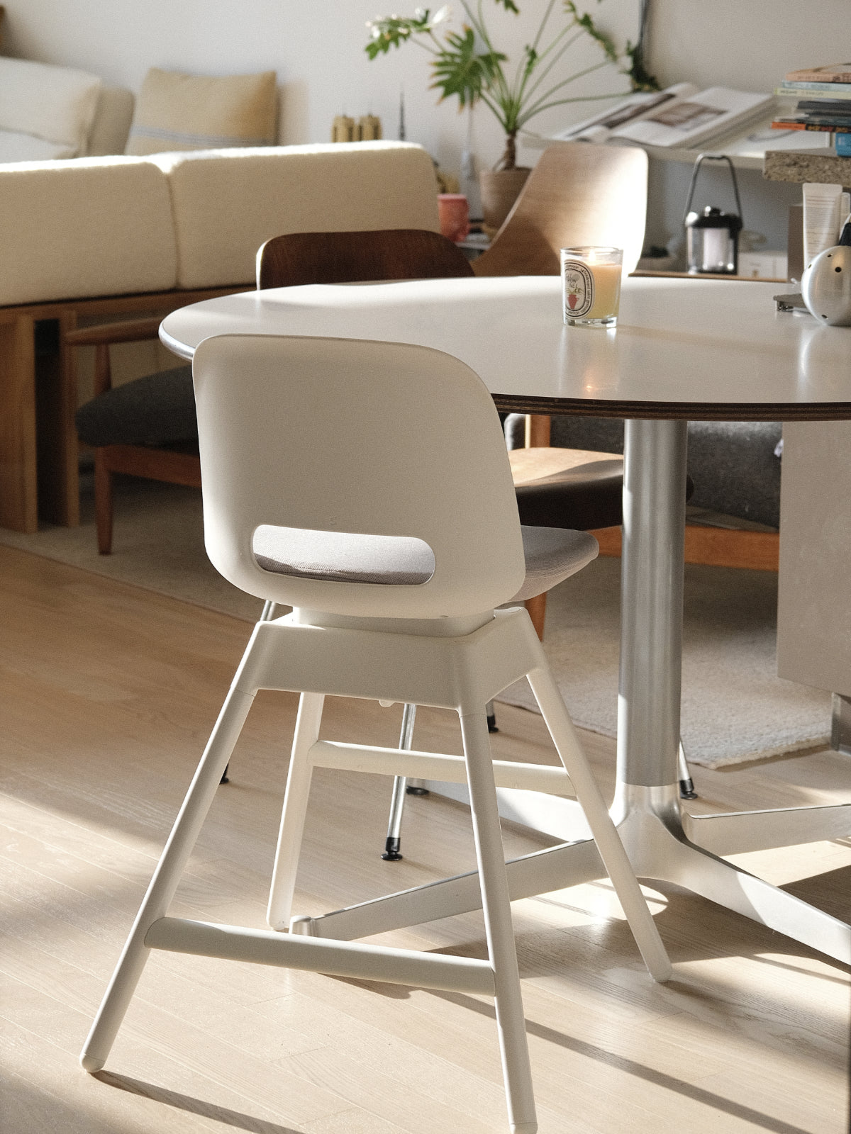 TREVO growing chair beside a family dining table