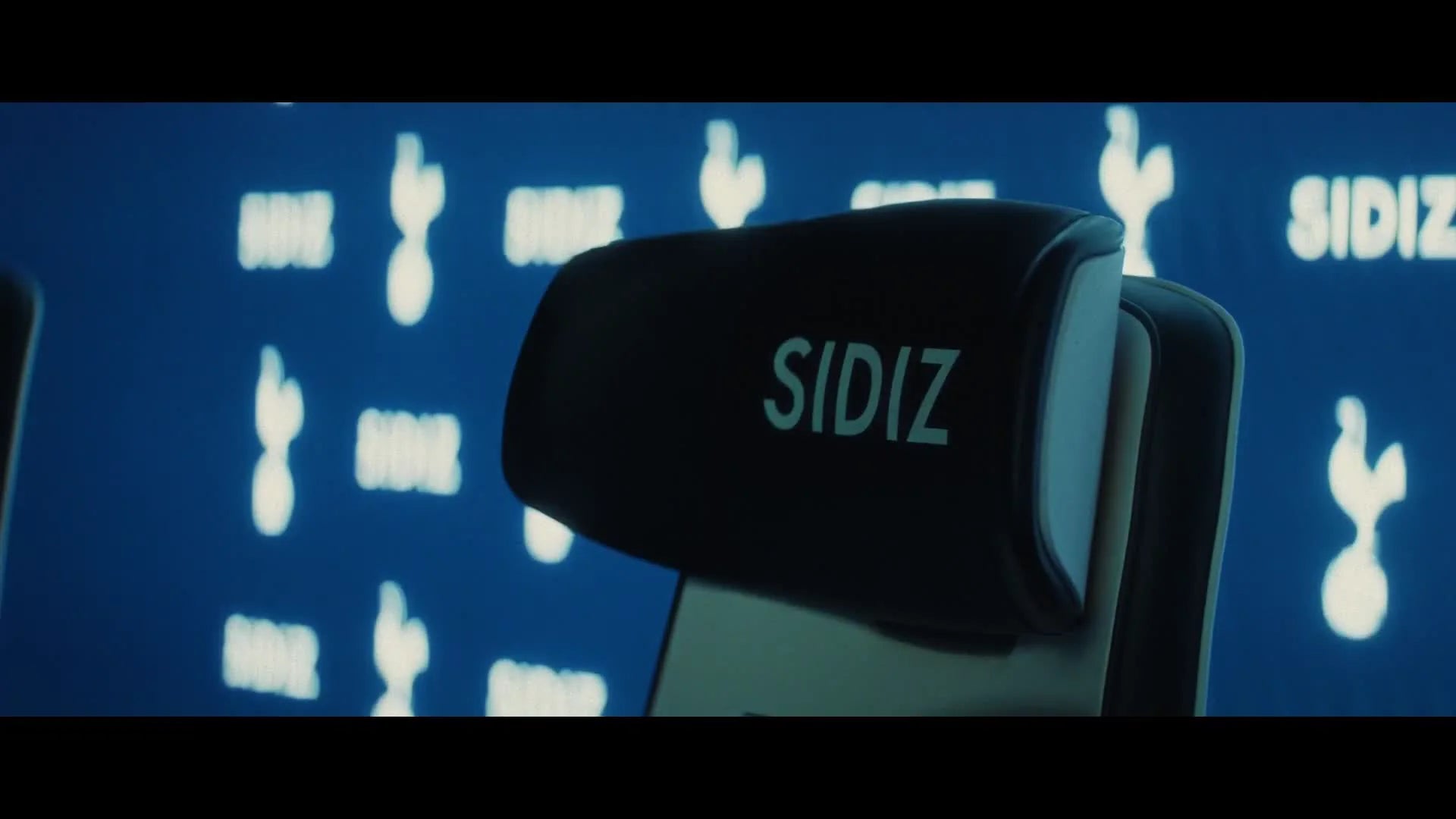 SIDIZ chair in front of Tottenham Hotspur and SIDIZ media-wall branding